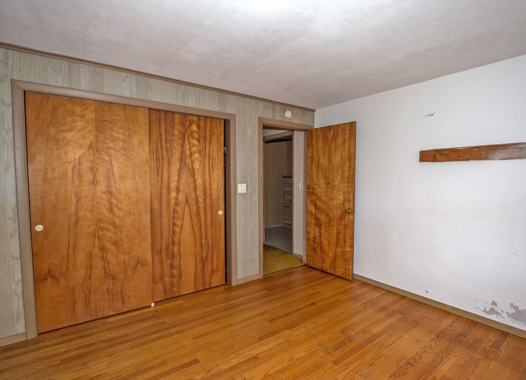 104 D Four Bridges Road Somers, CT 06071 - Photo 20 of 40 a view of an empty room with wooden floor and a window