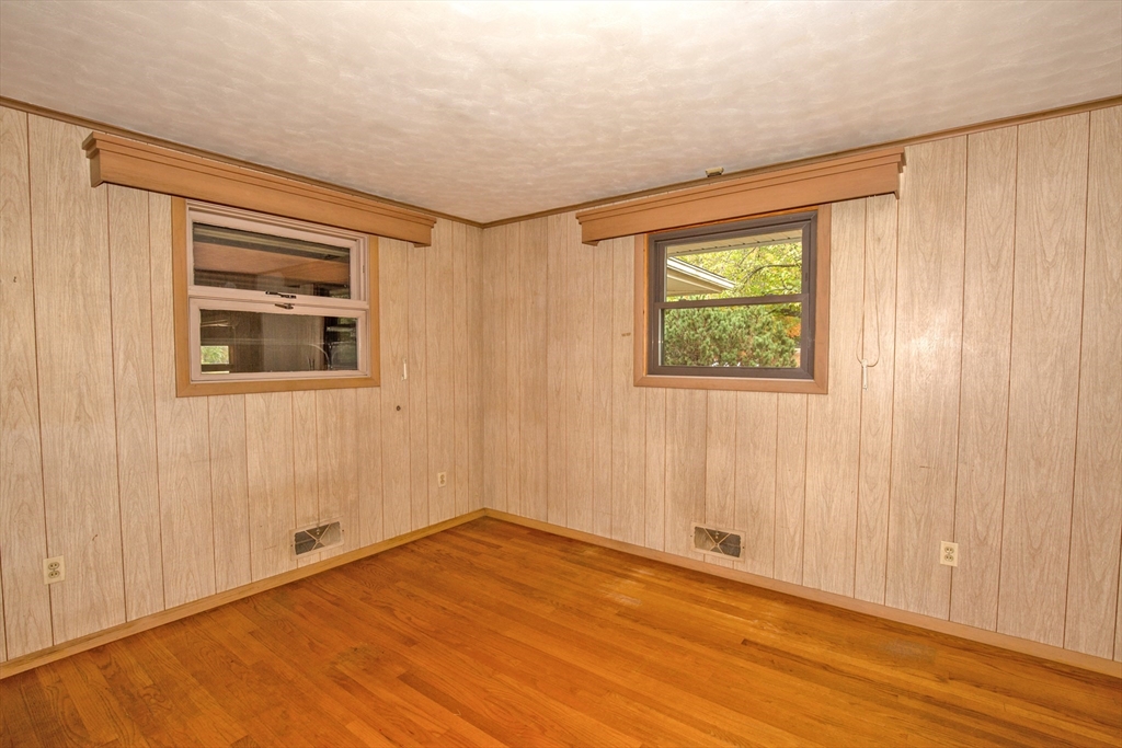 104 D Four Bridges Road Somers, CT 06071 - Photo 21 of 40 a view of an empty room with a window and hardwood floor