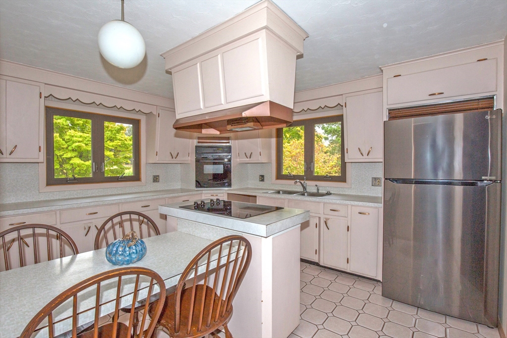 104 D Four Bridges Road Somers, CT 06071 - Photo 6 of 40 a kitchen with stainless steel appliances granite countertop a stove a sink and a refrigerator