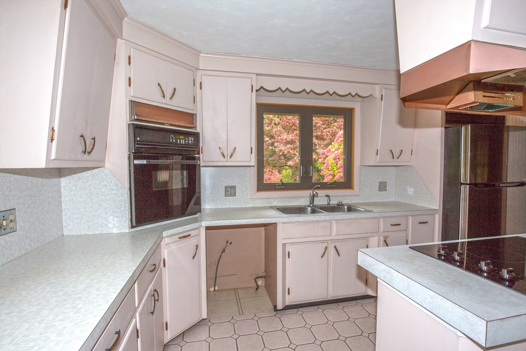 104 D Four Bridges Road Somers, CT 06071 - Photo 9 of 40 a kitchen with white cabinets and white appliances