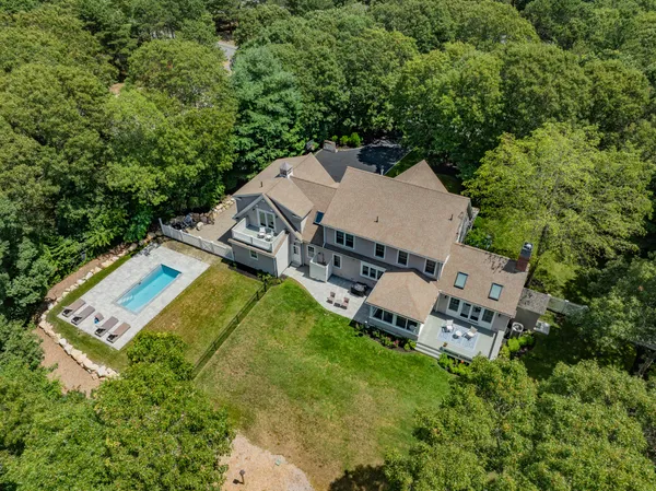 an aerial view of a house with a garden and trees