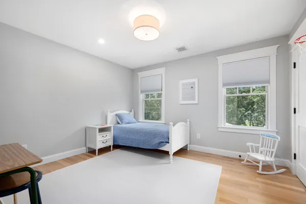 a spacious bedroom with a large bed and a large window