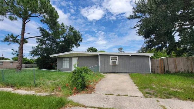 a front view of a house with a yard and trees