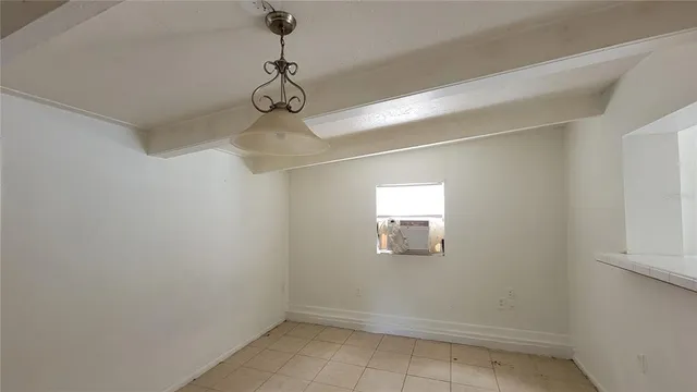 a view of a room with a window and a fan