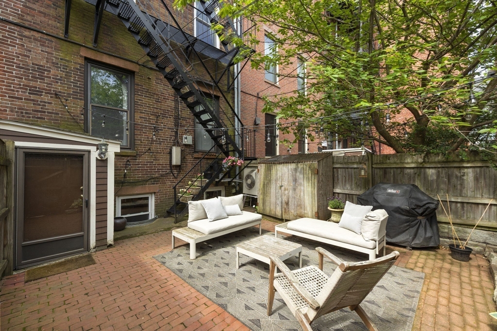 35 High Street, Unit 1 Boston, MA 02129 - Photo 30 of 33 a view of a patio with a table chairs and a fire pit