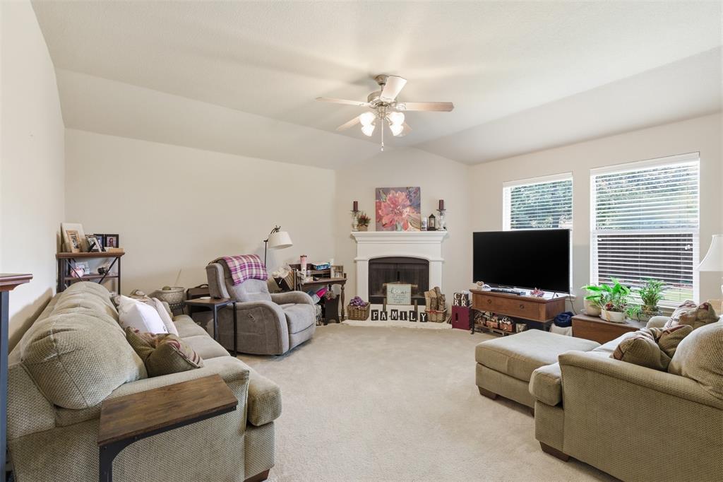 5491 Exeter Drive Prosper, TX 75078 - Photo 7 of 20 a living room with furniture a fireplace and a flat screen tv