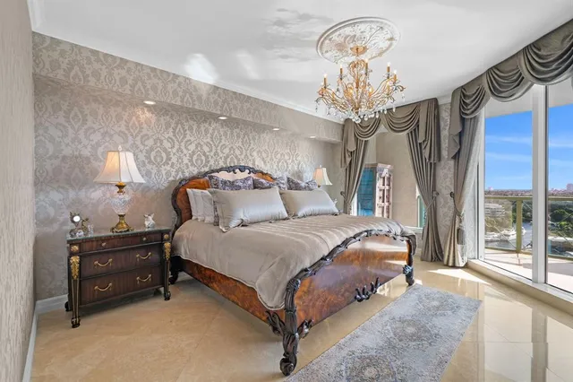 a bedroom with a bed and a chandelier