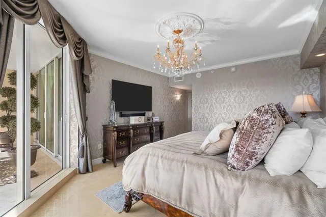 a bedroom with a large bed and a flat tv screen on dresser