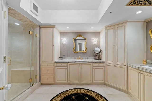 a spacious bathroom with a granite countertop sink a mirror and shower