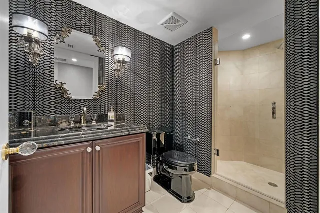 a bathroom with a sink toilet and shower