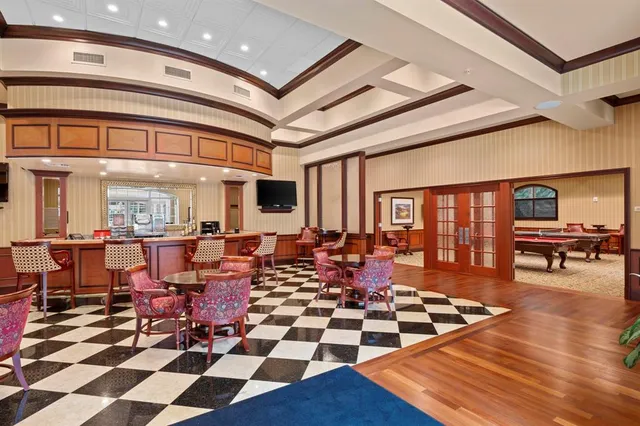 a room with lots of white furniture and glass windows