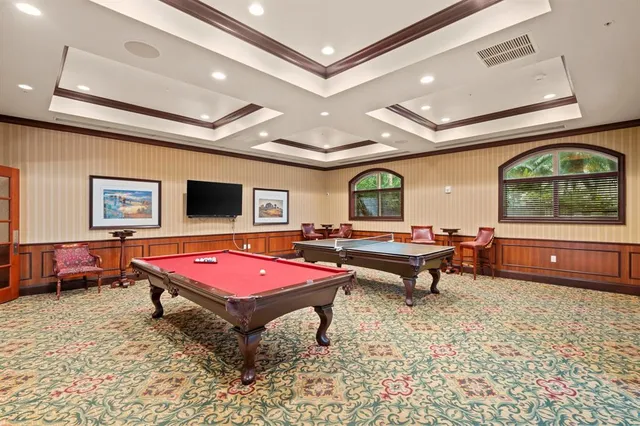 a living room with furniture a pool table and a flat screen tv