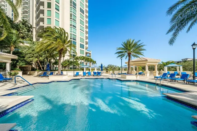 a view of yard with swimming pool and lawn chairs