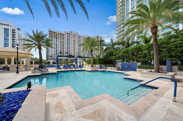a view of a swimming pool with chairs in patio