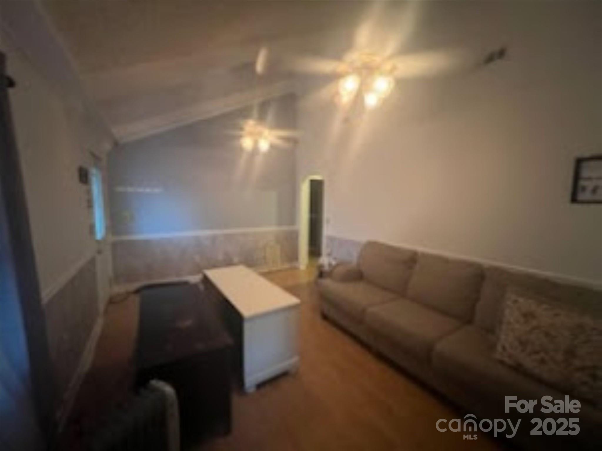 453 Marion Street Calhoun Falls, SC 29628 - Photo 17 of 24 a living room with furniture and a lamp