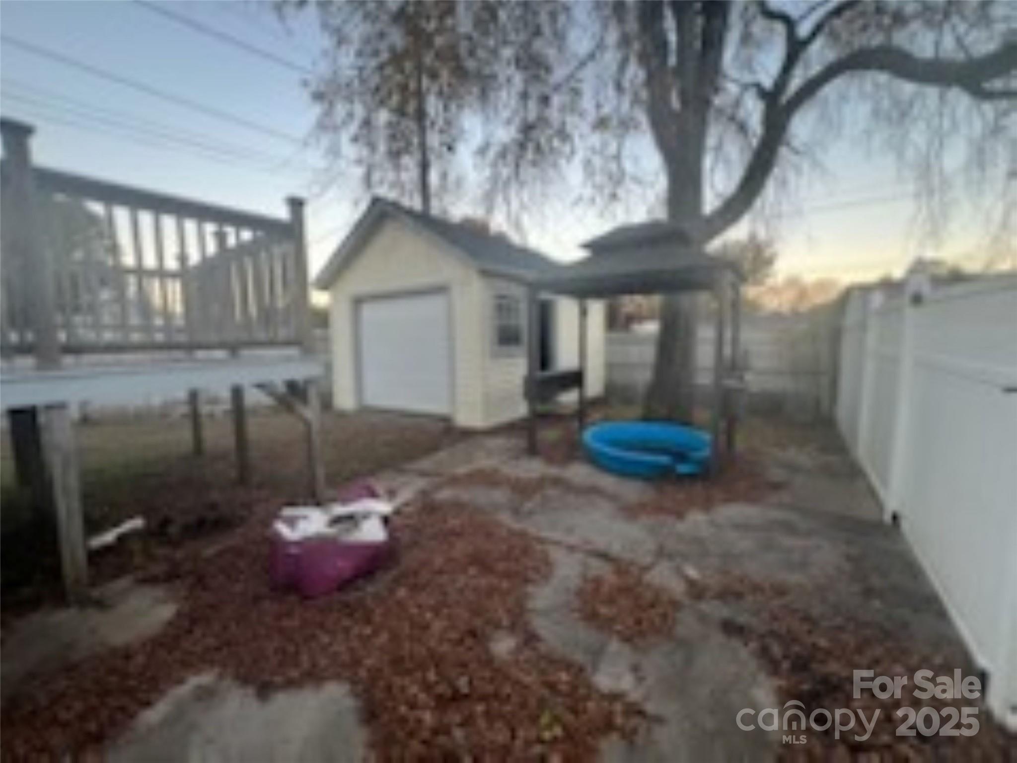 453 Marion Street Calhoun Falls, SC 29628 - Photo 18 of 24 a view of a backyard with table and chairs and fire pit