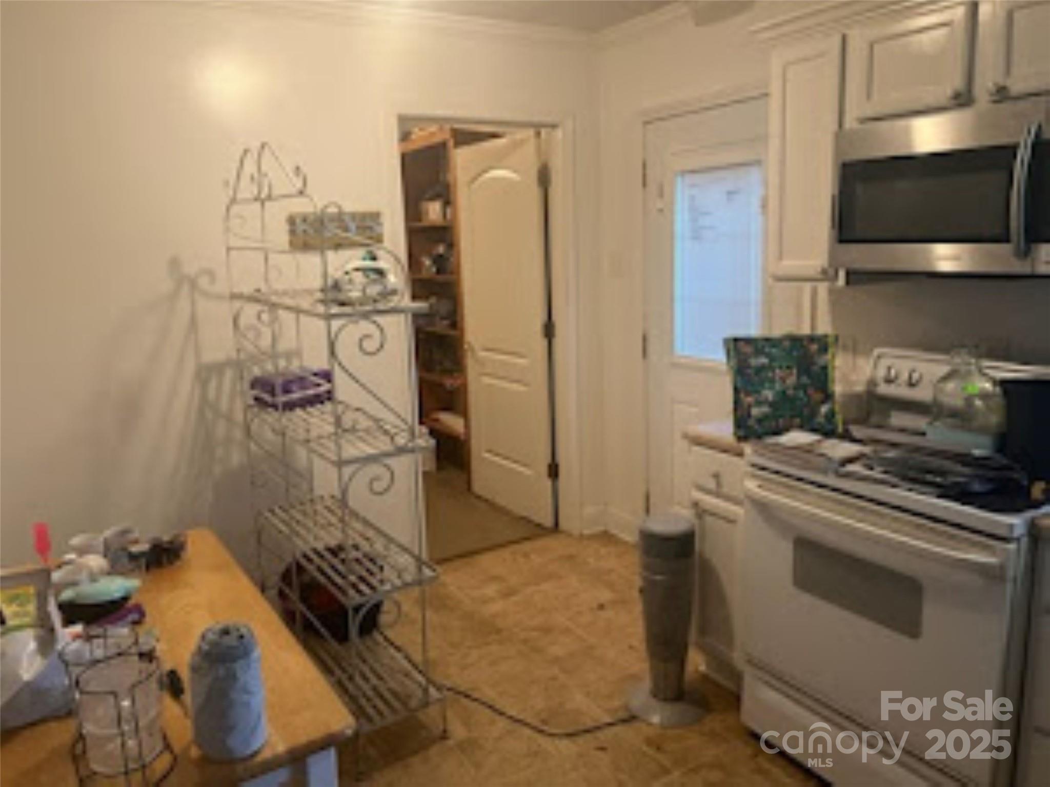 453 Marion Street Calhoun Falls, SC 29628 - Photo 4 of 24 a kitchen with stainless steel appliances granite countertop a stove and a microwave