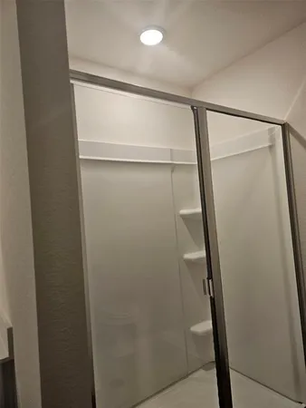 a bathroom with a glass shower door