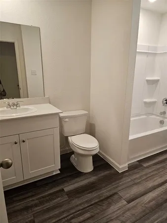 a bathroom with a toilet a sink and bathtub