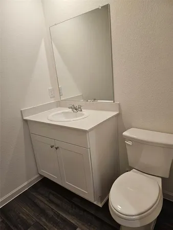 a bathroom with a toilet a sink and mirror