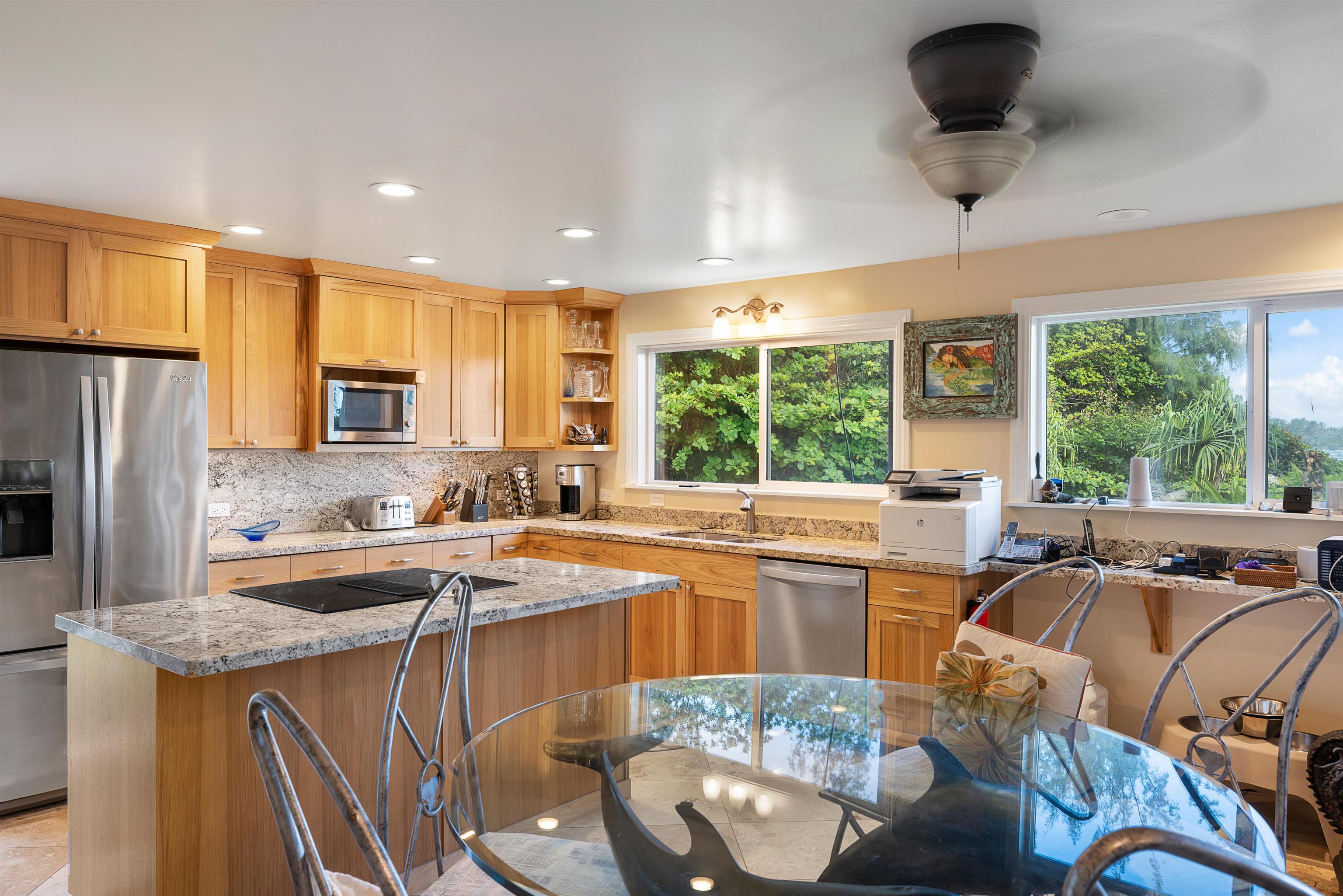 140 Waikoloa Road Hana, HI 96713 - Photo 16 of 32 a kitchen with stainless steel appliances granite countertop a sink stove and refrigerator