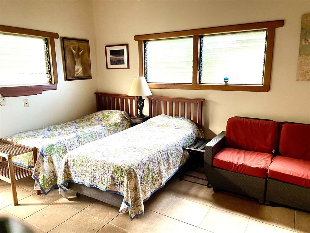 140 Waikoloa Road Hana, HI 96713 - Photo 23 of 32 a bedroom with two beds and a window