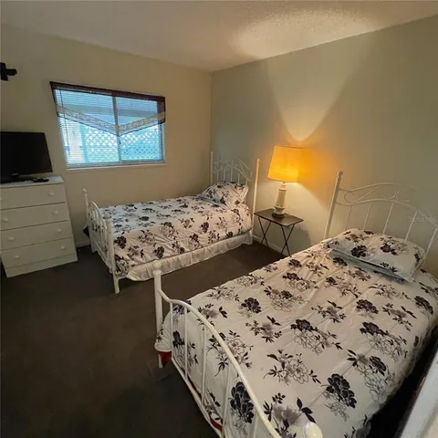 a bedroom with two beds and a window