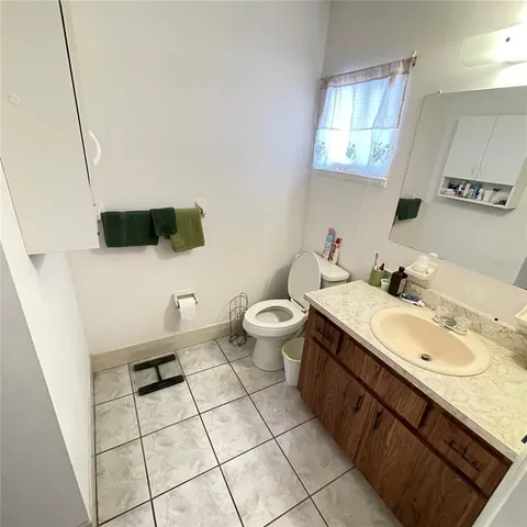 a spacious bathroom with a double vanity sink mirror and toilet
