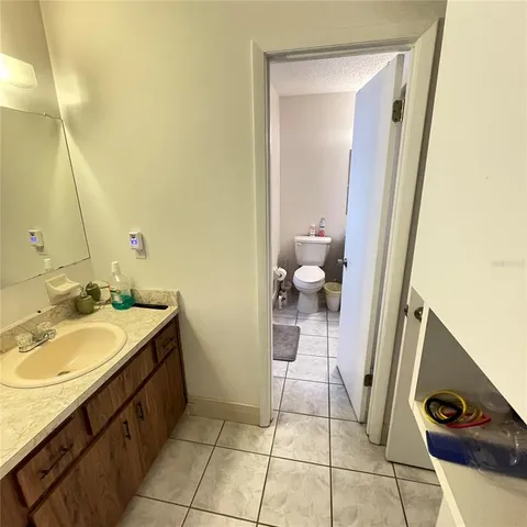 a bathroom with a sink a toilet and mirror
