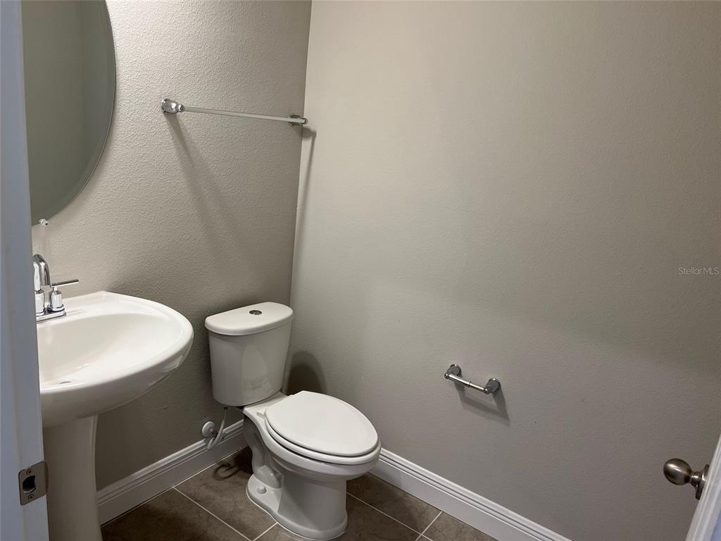 2232 Shadowland Loop Winter Park, FL 32792 - Photo 12 of 12 a white toilet sitting next to a white sink and vanity