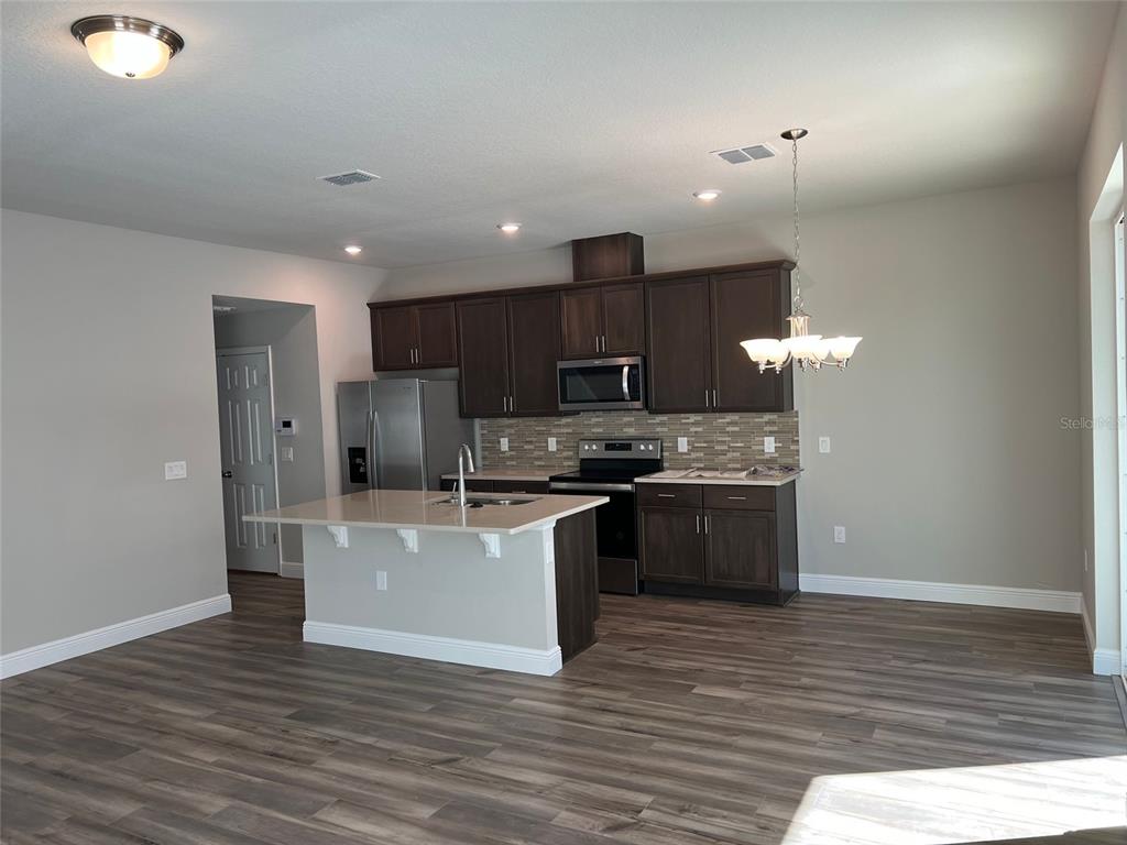 2232 Shadowland Loop Winter Park, FL 32792 - Photo 3 of 12 a kitchen with stainless steel appliances a refrigerator and a stove top oven