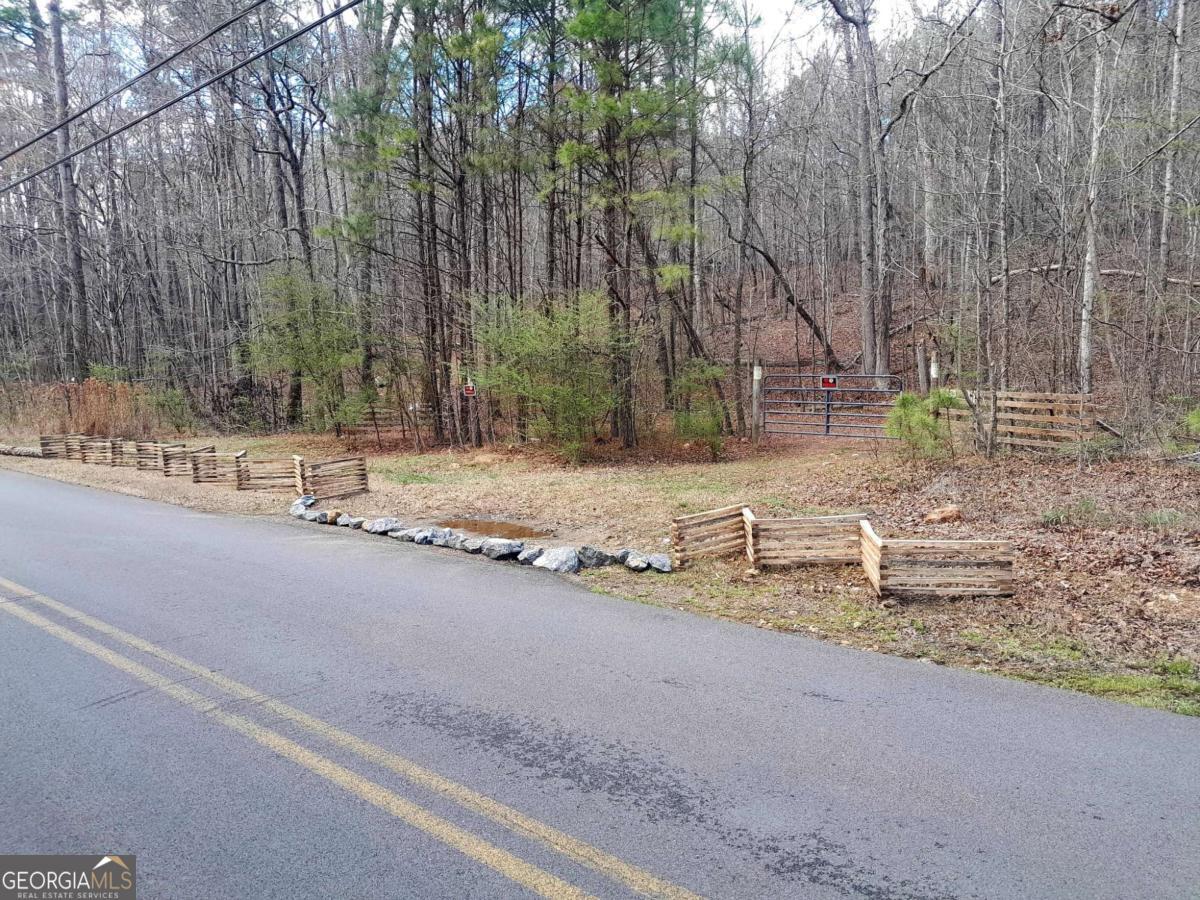 0 East Hermitage Road Northeast, Unit LOT 6 Rome, GA 30161 - Photo 43 of 44 a backyard of a house with large trees and covered with wooden fence