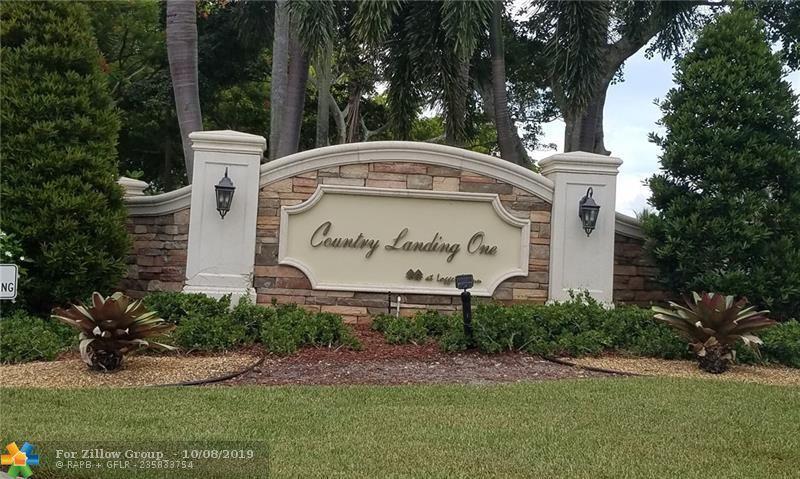 11402 Country Sound Court Boca Raton, FL 33428 - Photo 19 of 22 a view of outdoor space with garden and trees