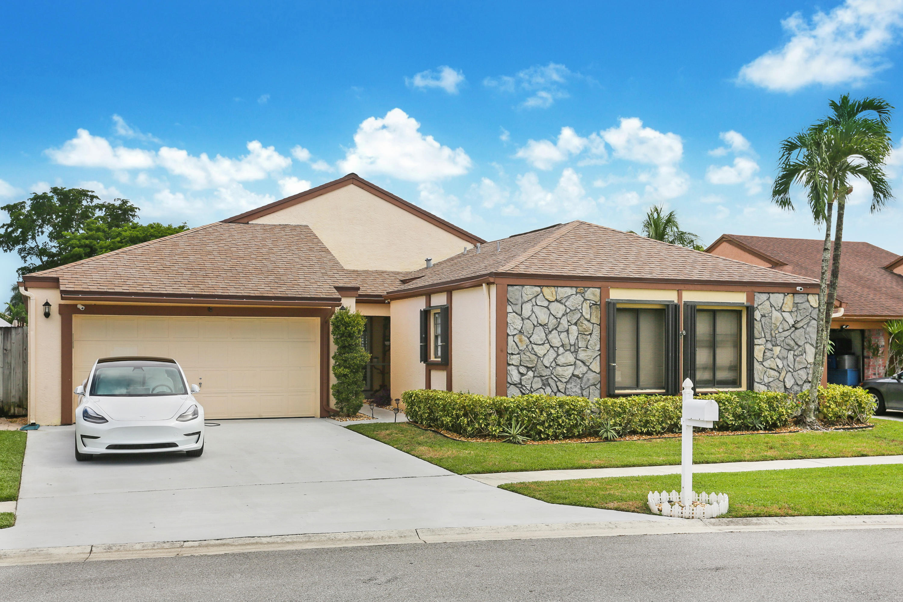 11402 Country Sound Court Boca Raton, FL 33428 - Photo 2 of 22 a front view of a house with a yard
