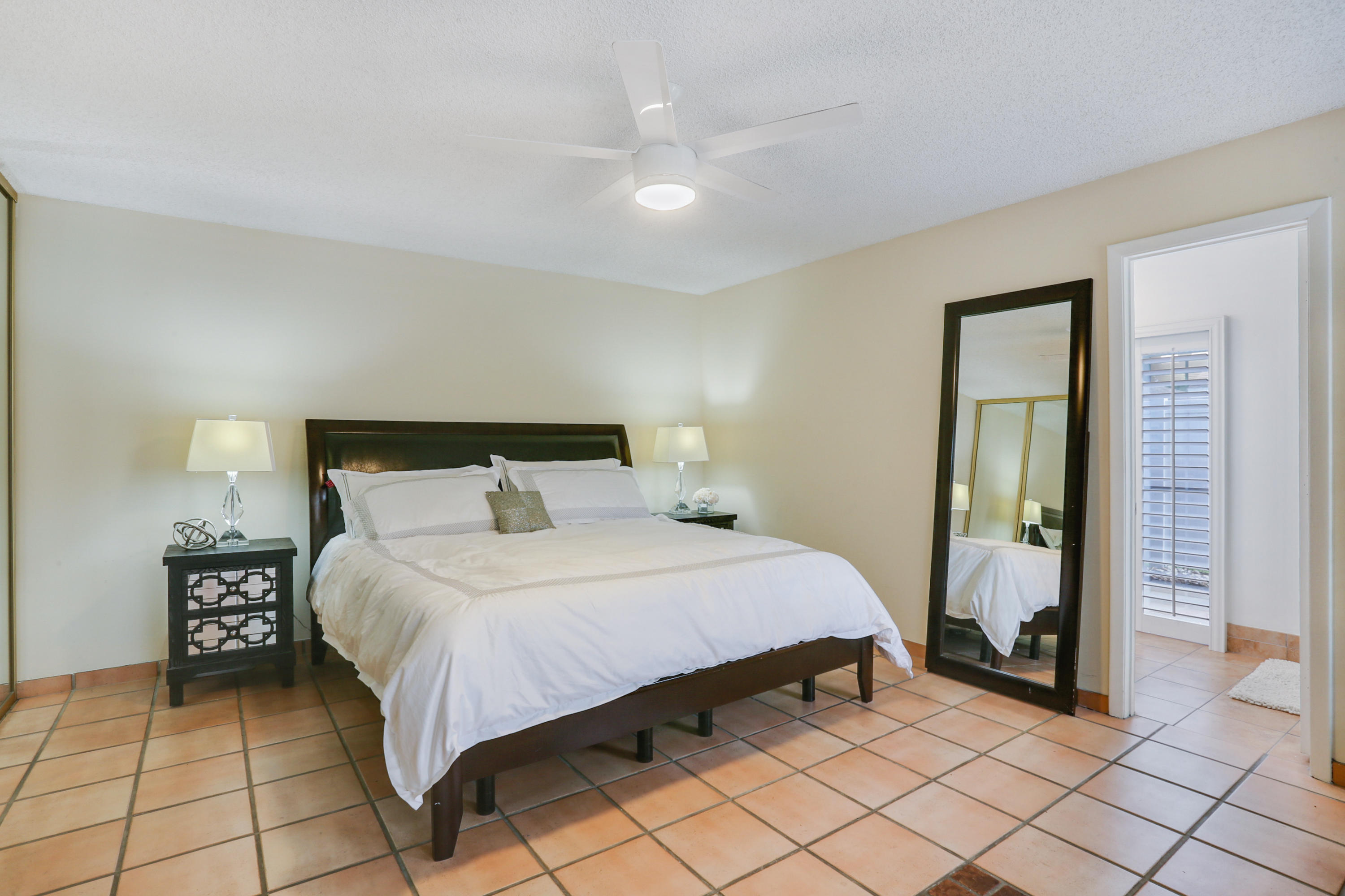 11402 Country Sound Court Boca Raton, FL 33428 - Photo 9 of 22 a bedroom with a bed and a mirror