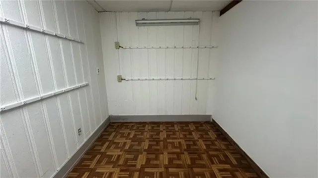 a view of an empty room with wooden floor