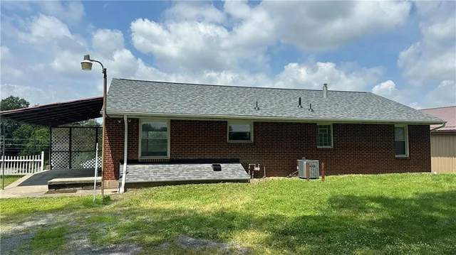 a view of a house with backyard and porch