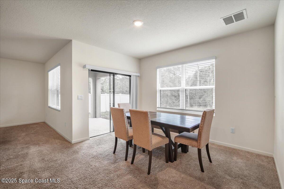 1841 Saxton Road Cocoa, FL 32926 - Photo 18 of 45 a view of a dining room with furniture and a window