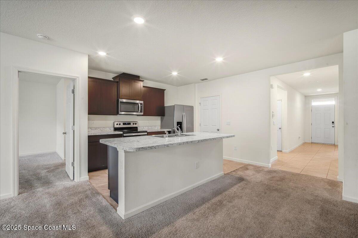 1841 Saxton Road Cocoa, FL 32926 - Photo 22 of 45 a kitchen with kitchen island a sink stainless steel appliances and cabinets
