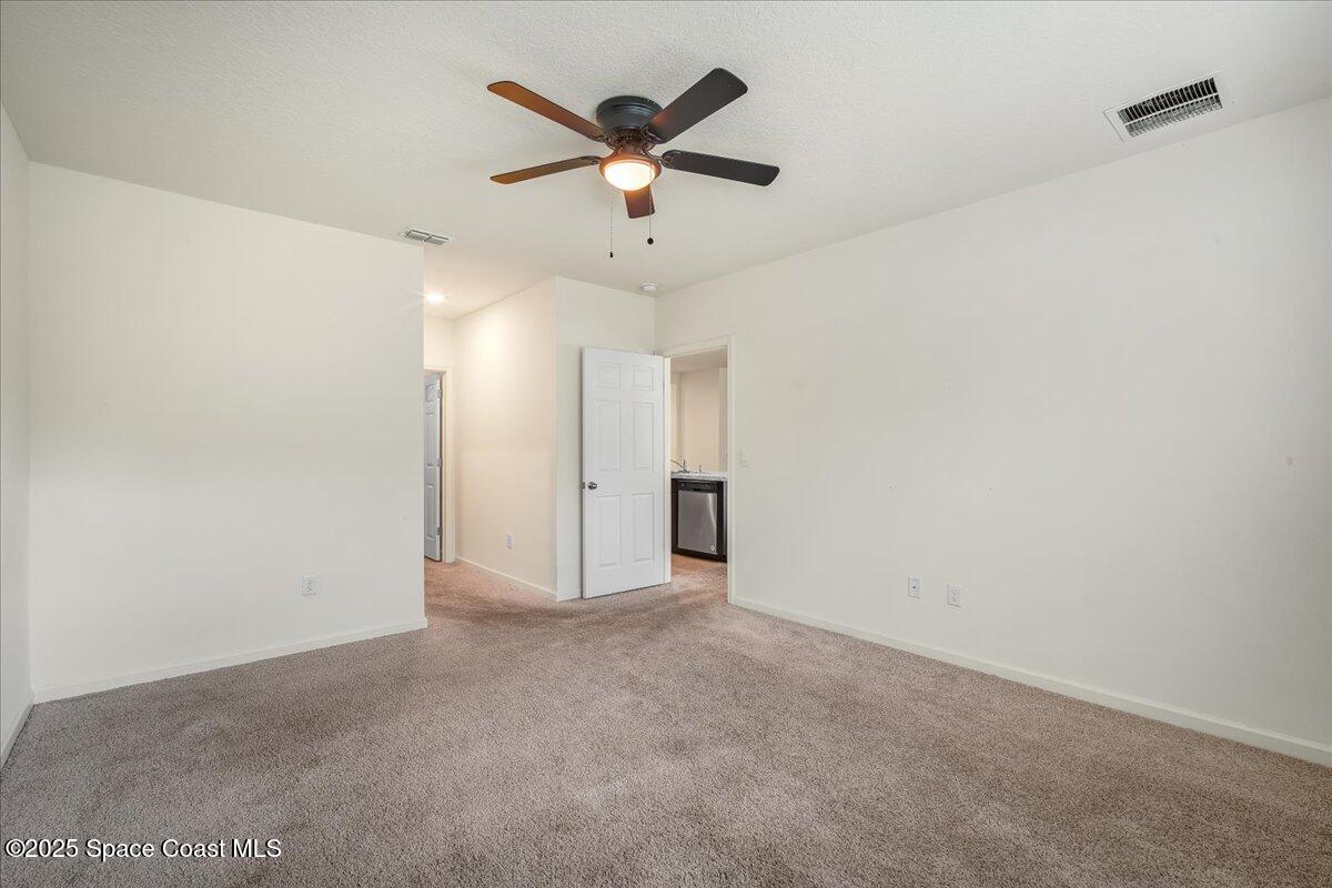 1841 Saxton Road Cocoa, FL 32926 - Photo 24 of 45 an empty room with ceiling fan
