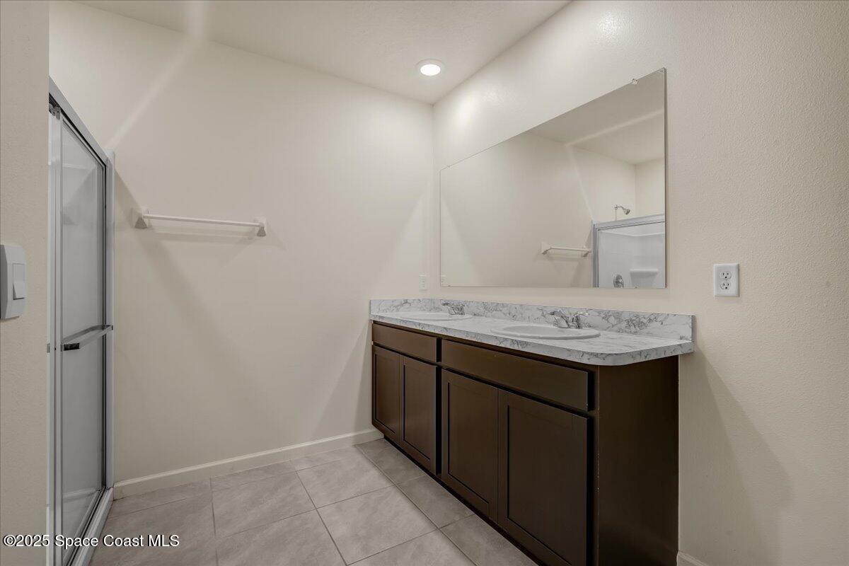 1841 Saxton Road Cocoa, FL 32926 - Photo 26 of 45 a bathroom with a sink and a mirror