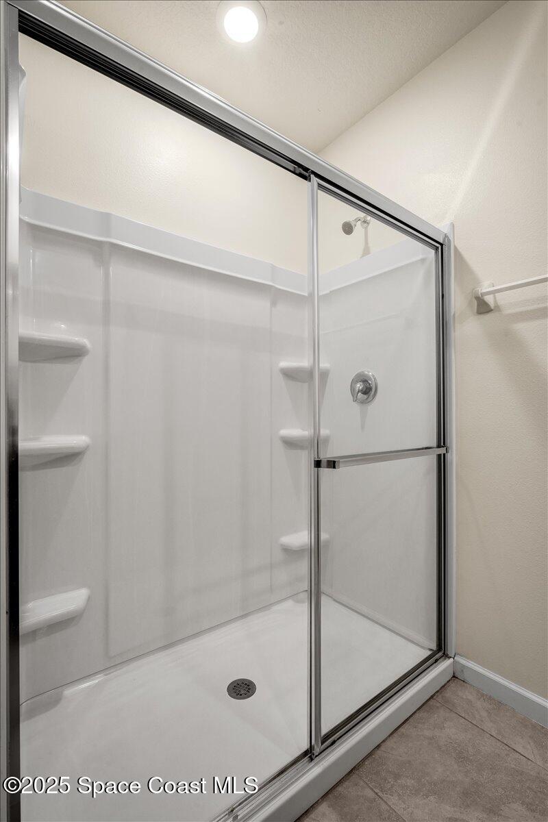1841 Saxton Road Cocoa, FL 32926 - Photo 27 of 45 a bathroom with a glass shower door