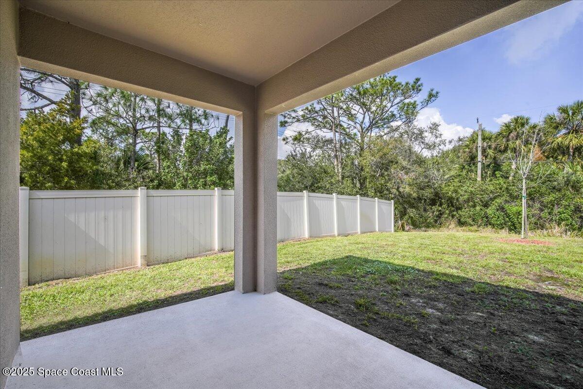 1841 Saxton Road Cocoa, FL 32926 - Photo 31 of 45 a view of a backyard with plants and large trees