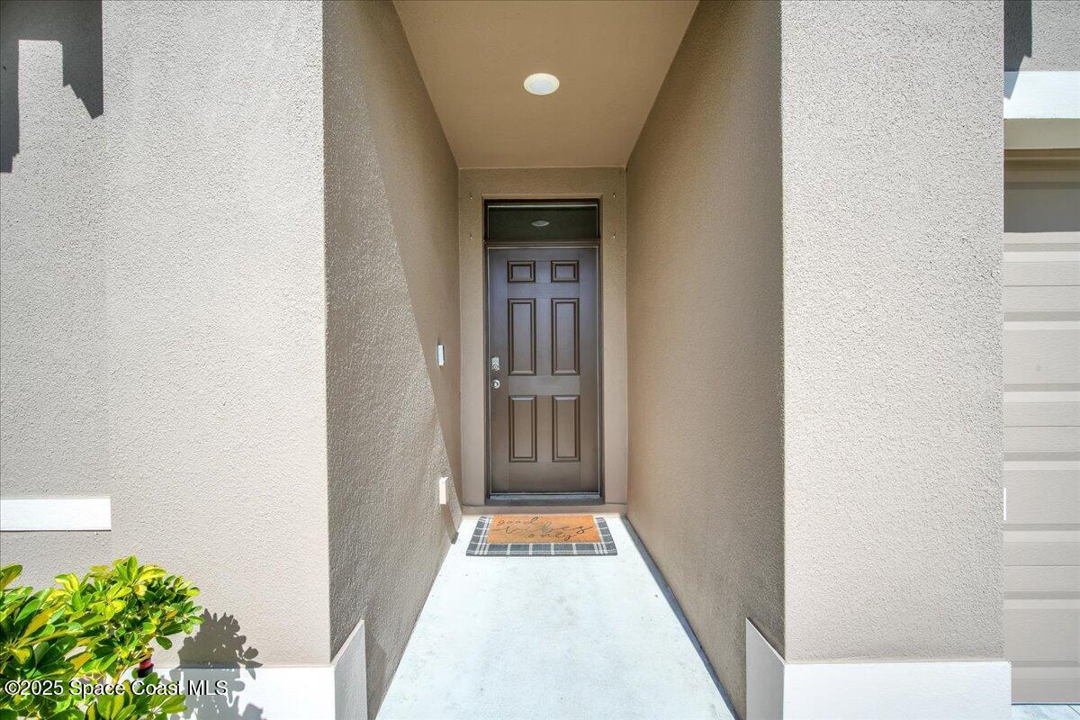 1841 Saxton Road Cocoa, FL 32926 - Photo 8 of 45 a view of a hallway with wooden floor and a bathroom