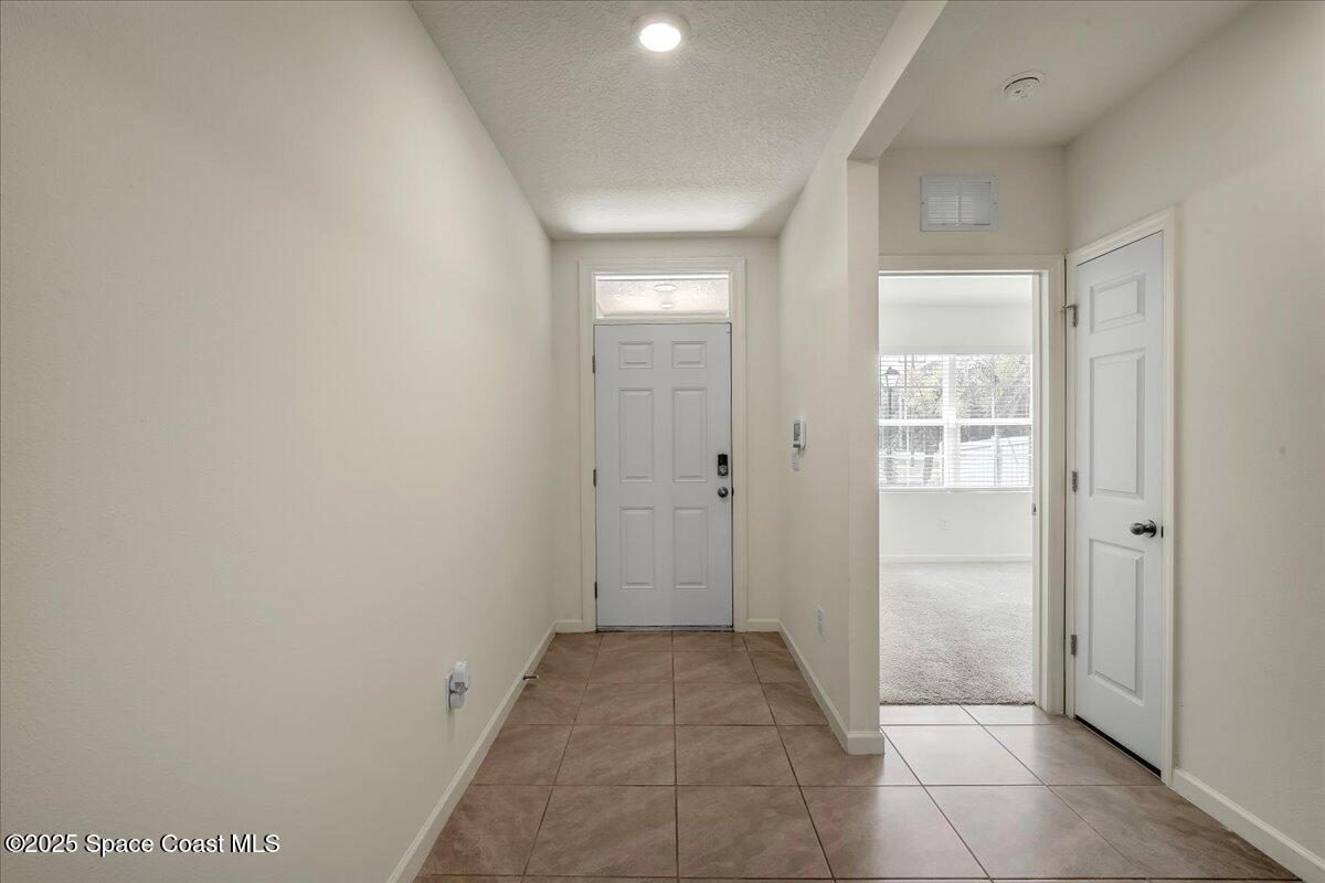1841 Saxton Road Cocoa, FL 32926 - Photo 10 of 45 a view of a hallway to rooms