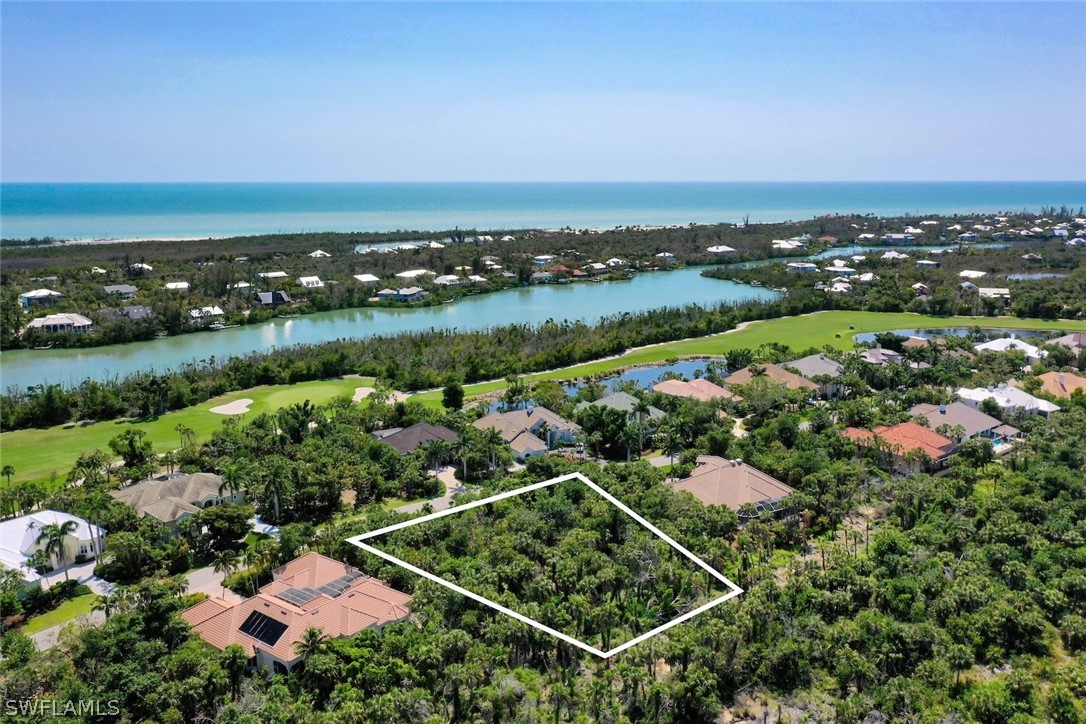 2348 Wulfert Road Sanibel, FL 33957 - Photo 18 of 24 an aerial view of a city with lots of residential buildings and ocean view in back