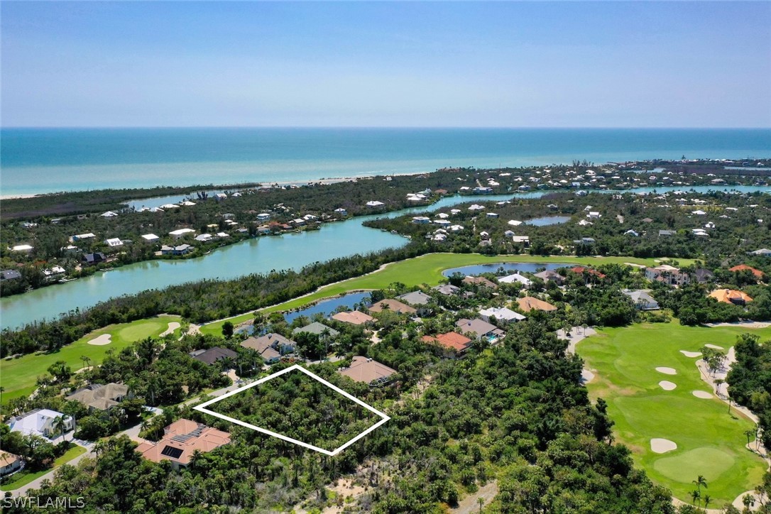 2348 Wulfert Road Sanibel, FL 33957 - Photo 9 of 24 an aerial view of a city with lots of residential buildings and ocean view in back