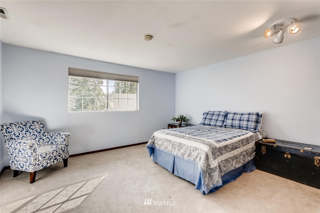 1908 233rd Place Southeast Bothell, WA 98021 - Photo 13 of 24 a bed sitting in a bedroom next to a window