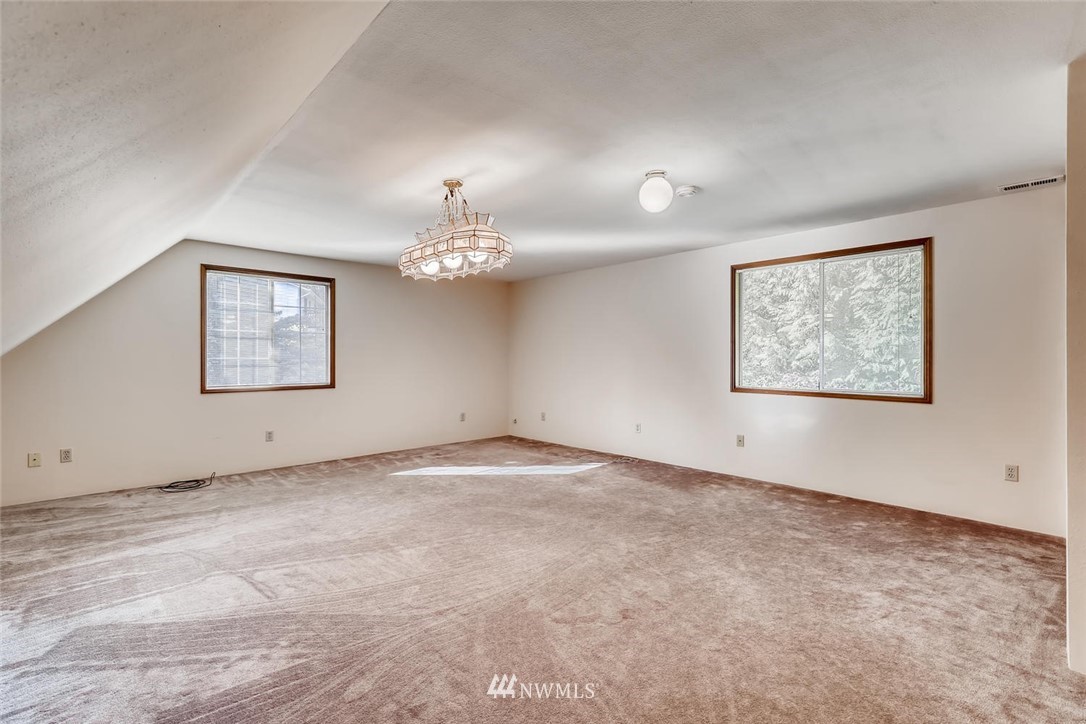 1908 233rd Place Southeast Bothell, WA 98021 - Photo 14 of 24 a view of an empty room with a painting on the wall