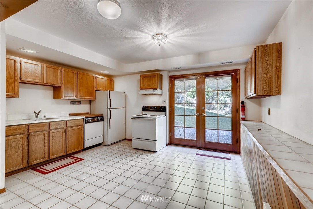 1908 233rd Place Southeast Bothell, WA 98021 - Photo 18 of 24 a kitchen with a sink appliances cabinets and furniture